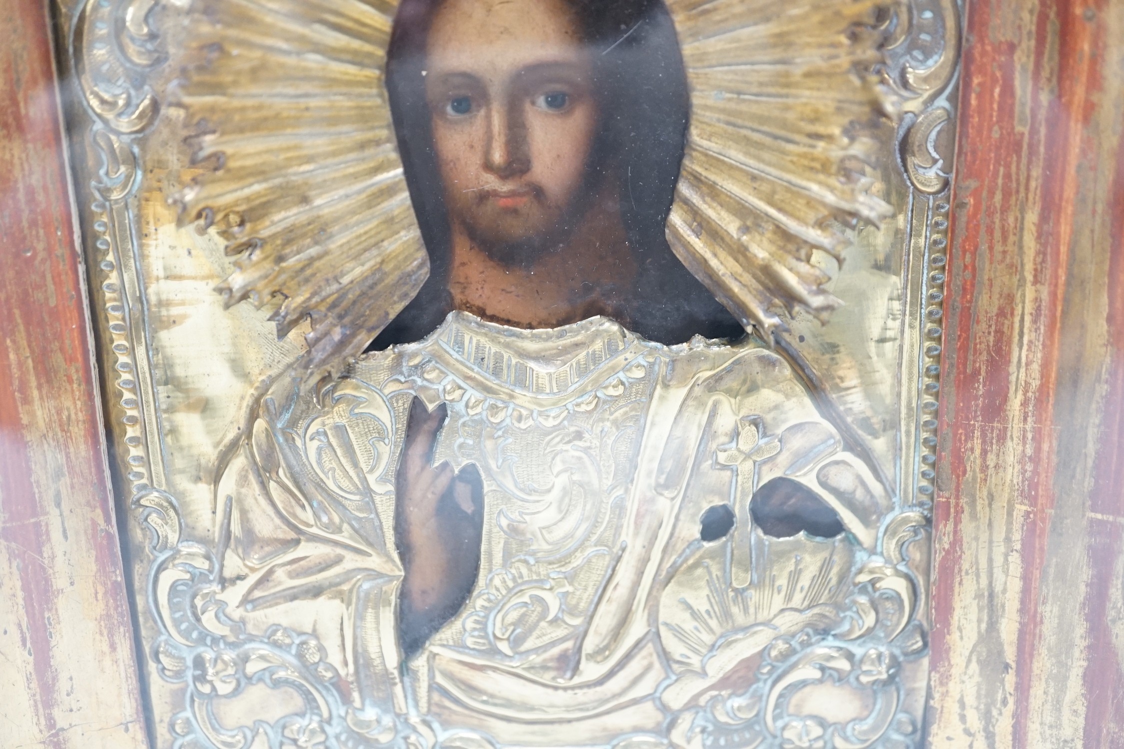 A late 19th- early 20th century Russian icon, in case, 28cms high x 25cms wide in total